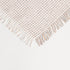 corner picture of a fall plaid throw blanket made from a polyester blended fabric showing fringe